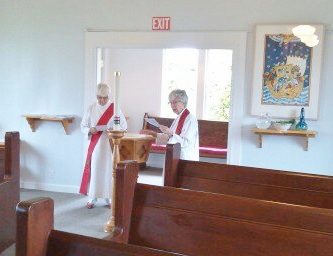 Rev. Lorraine (right) leads the renewal of baptismal vows.